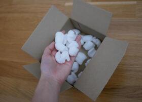 Ecological packaging of parcel box filled with biodegradable filler. The concept of delivery service and recycling photo