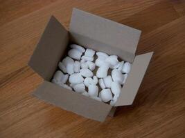 Ecological packaging of parcel box filled with biodegradable filler. The concept of delivery service, recycling photo