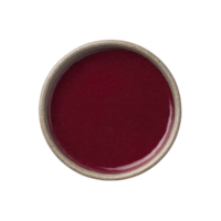 Round ceramic bowl filled with vibrant red liquid, possibly sauce or soup, viewed from above. smooth surface and rich color create striking visual contrast with neutral toned bowl png