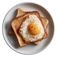 Delicious fried egg served on golden toast. Perfectly cooked with a sunny yolk, garnished with spices. Ideal for breakfast or brunch, showcasing appetizing presentation. png