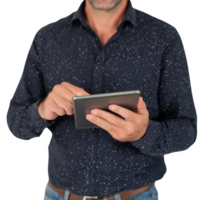 A man using a tablet device with a focused expression, dressed in a dark patterned shirt, standing against a white isolated background. png