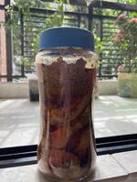 A jar of food sitting on a table photo