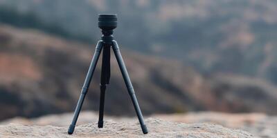 Professional Tripod on a Rocky Summit Capturing Breathtaking Landscape Views photo