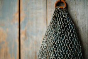 Rustic Fishing Net Hanging on Weathered Wood A Vintage Coastal Image photo