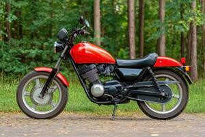Red Classic Vintage Motorcycle in a Forest Setting A Stunning Image of a Retro Custom Bike, Perfect for Enthusiasts and Collectors. photo
