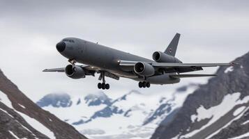 Majestic Military Airplane Landing in Snowy Mountainous Landscape photo