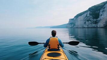 Serene Kayaking Experience amidst Majestic Cliffs and Tranquil Water photo