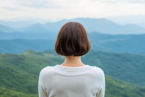 Woman Contemplating Majestic Mountain Views A Peaceful Moment in Nature photo
