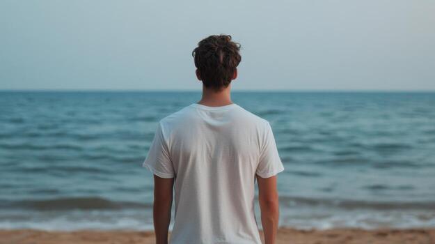 Contemplative Man on the Beach, Reflecting on the Oceans Serenity photo