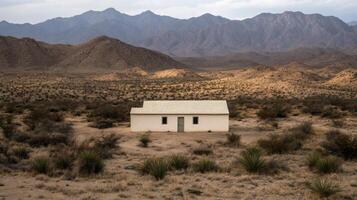 Solitude in the Desert A Simple White House Amidst the Vast Landscape photo