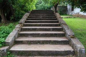 Ancient Stone Steps Leading Through a Lush Garden. A Majestic Architectural Feature in a Peaceful Park Setting. photo