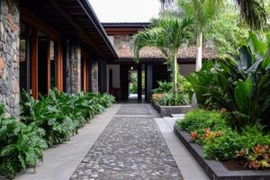 Stunning Modern Tropical Courtyard Design with Lush Greenery and Stone Path photo