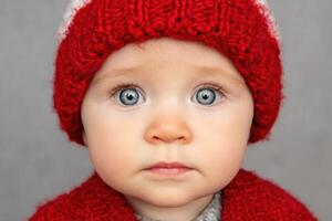Portrait of a Baby in a Red Knitted Hat photo