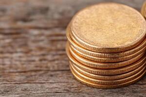Golden Coin Stacks on Rustic Wooden Surface Financial Prosperity photo