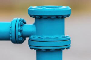 of a vibrant blue industrial pipe joint. A detailed view of the connection components. Industrial engineering masterpiece. photo
