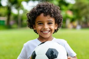 Smiling Child Holding Soccer Ball in Park photo