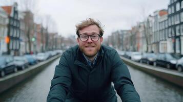 Smiling Man in Amsterdam Canal Cityscape. Urban Portrait of a Happy Person photo