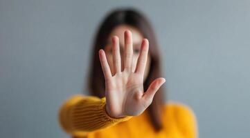 Woman's Hand Showing Stop Gesture Powerful Symbol of Refusal, Rejection, and Self Protection photo