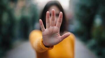 A Woman's Hand in a Stop Gesture A Powerful Image of Refusal, Rejection, and Setting Boundaries. This image conveys strength and r photo