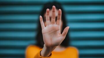 A Woman's Hand Showing Stop Gesture Nonverbal Communication, Rejection, and Boundaries. High quality image of a hand signaling to photo