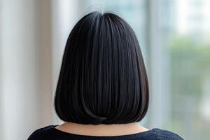 Stunning Black Bob Hairstyle A Smooth, Sleek, and Elegant Look for Women. This image showcases a woman's gorgeous, healthy, shiny photo