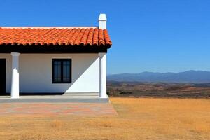 Mediterranean House with Mountain View A Stunning Architectural Design in a Dry Landscape. The house features a red tile roof, whi photo