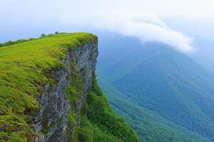 Majestic Mountaintop Cliffside Landscape A Breathtaking View of Verdant Valley and Rolling Hills Bathed in Soft Light. Explore the photo