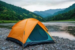 Camping Adventure A Serene Escape by the River. Explore the tranquil beauty of nature, surrounded by majestic mountains and lush g photo