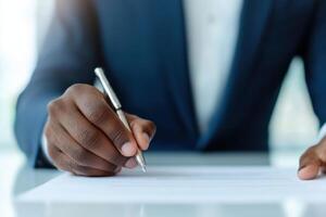 of a hand signing a contract. A business deal is finalized, signifying success, growth, and progress in a professional office set photo