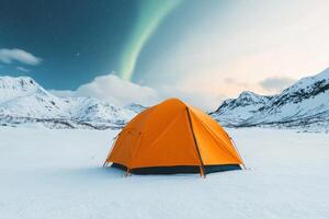 Winter Camping Adventure Orange Tent Under the Aurora in Snowy Mountains. Escape to serenity, explore the wild, and embrace the ch photo