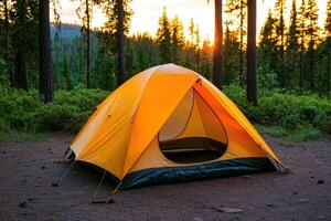 Camping Adventure A Sunset in the Forest. Explore the serene beauty of nature with this captivating image of a tent nestled among photo