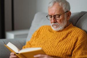 A Serene Moment An Elderly Gentleman Finds Solace in Reading a Book at Home. A Captivating Image Showcasing the Tranquility of Lei photo