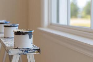 Interior Home Improvement Fresh Paint cans on a Stepladder near Window. Home Renovation, New House, Real Estate, Property, Constru photo