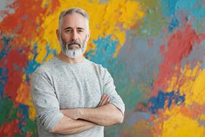 Portrait of a Mature Male Artist A Confident and Creative Expression in Front of an Abstract Colorful Background photo