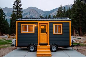 Modern Tiny House on Wheels in Mountain Landscape. A cozy and stylish small home, perfect for minimalist living and nature escapes photo