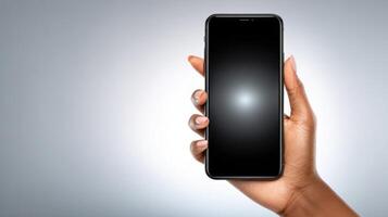of a hand holding a black smartphone with a blank screen. The image is perfect for showcasing mobile apps, technology, or communic photo