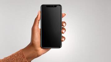 of a hand holding a black smartphone with a blank screen. The image showcases modern technology and mobile communication in a simp photo