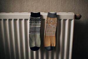 Cozy Winter Socks Drying on a Radiator A Symbol of Home Comfort and Warmth. Perfect for cold days, these stylish socks add a touch photo
