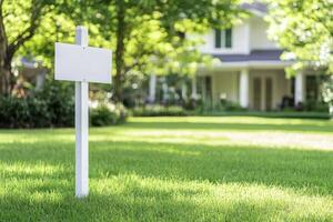 Empty sign on green lawn in front of a house for real estate or marketing photo