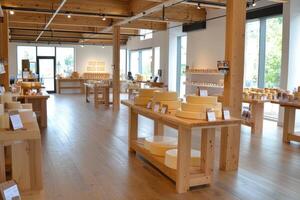 Cheese shop with wooden structure, displaying cheese wheels for sale to customers photo