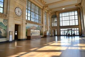 Empty train station hall, passengers arriving in background for transport photo