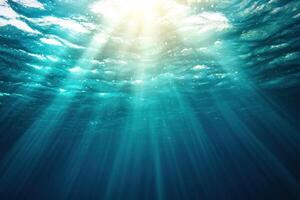 Sunlight shining underwater, creating light rays, for backgrounds or wallpaper use photo