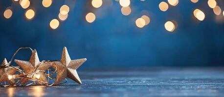 Golden star garland on table with twinkling lights for holiday decoration photo
