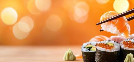 Sushi with chopsticks on table against bokeh background for restaurant menu photo