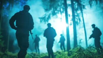 Soldiers patrol forest in smoke. Possible defense, security, war, or military use photo