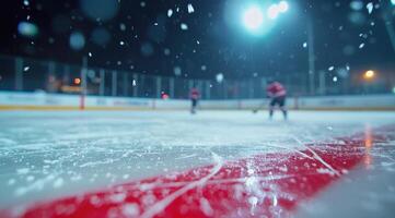 Hockey players practice on an outdoor rink at night during a snowfall photo