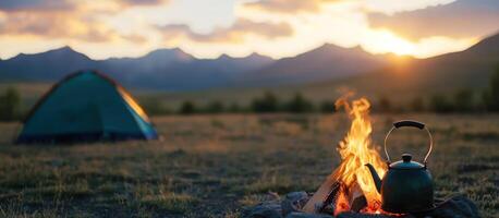 Campfire crackles with tent, teapot, mountains at sunset for outdoor adventures photo