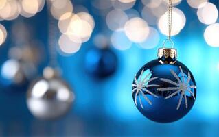 Blue Christmas ornament hanging with bokeh background, holiday decor photo
