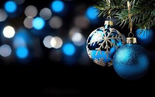Blue ornaments hanging on a Christmas tree with bokeh lights background photo