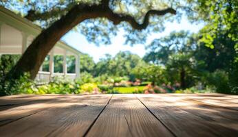 Wooden table in garden with house, sunny day, product placement photo